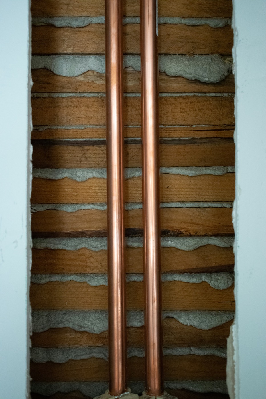 Copper pipework against timber laths