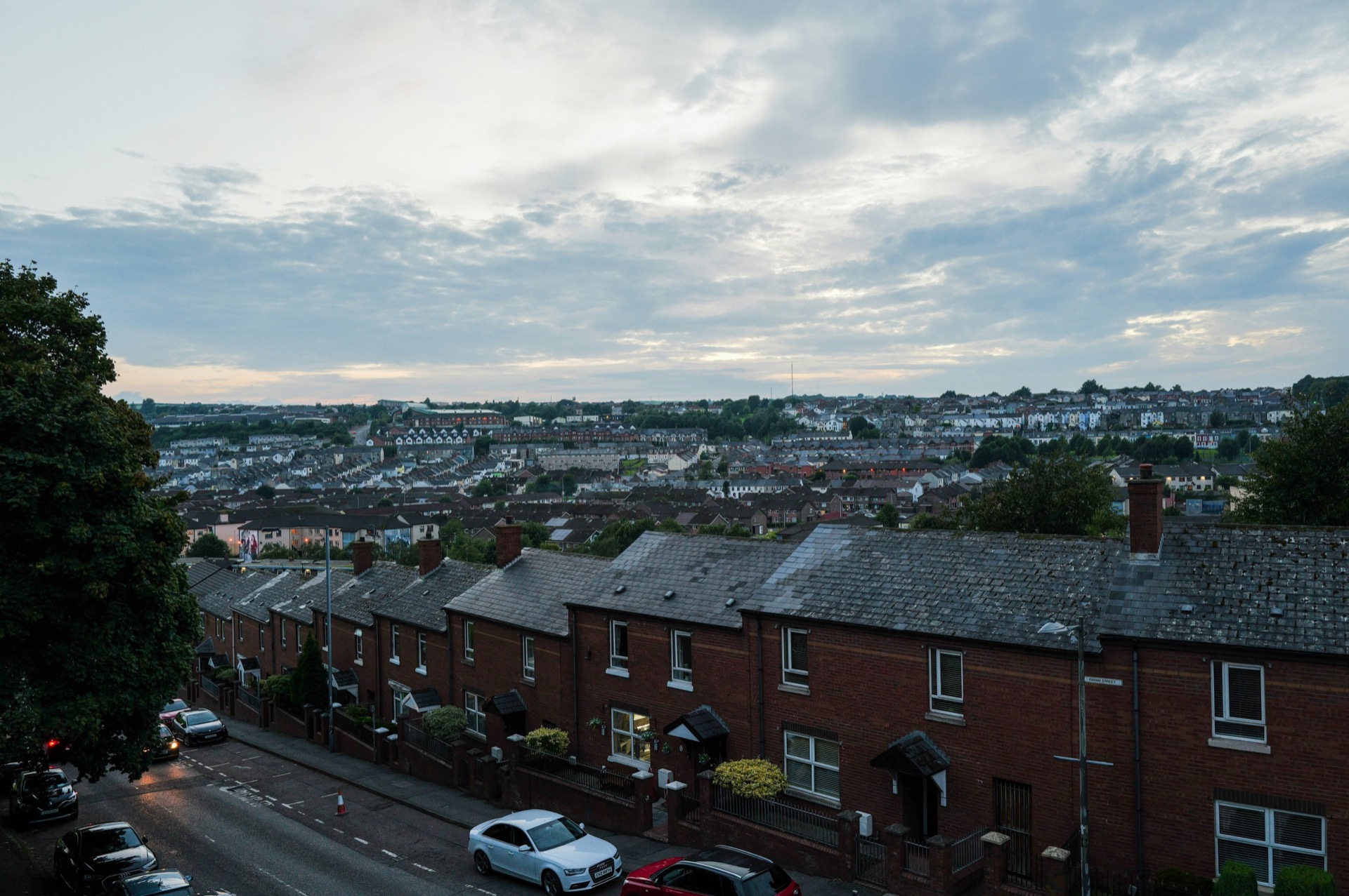 Rows of terraced houses under slate roofs on an overcast day